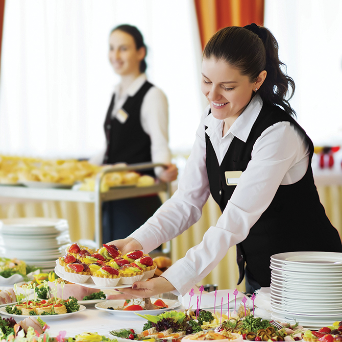 server place food on buffet at bear river