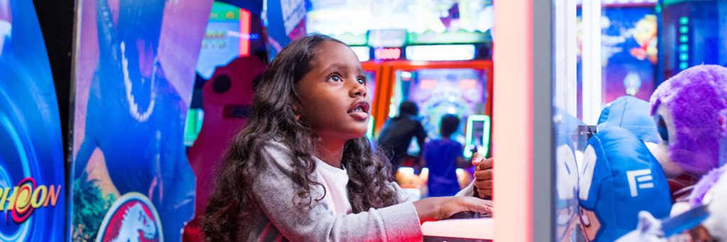 little girl playing arcade game at bear river